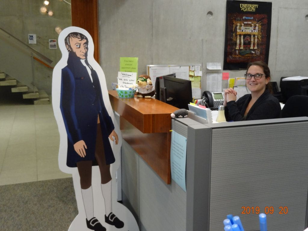 Life-size cut-out Avogadro at the office with undergraduate office with smiling women