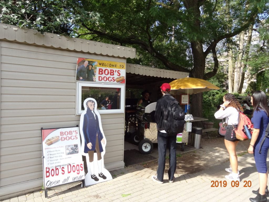 Life-size cut-out of Avogadro in front of a hot dog stand