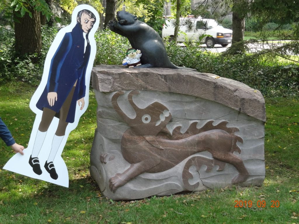 life-size cut-out of Avogadro in front of a white dome with molecules painted on it