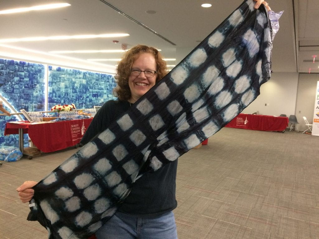 Yvonne Clifford holding a tie dyed scarf