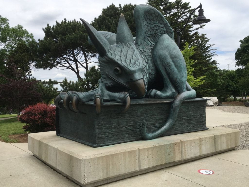 a large statue of a gryphon with a body, tail, and back legs of a lion; the head and wings of an eagle; and an eagle's talons as its front feet