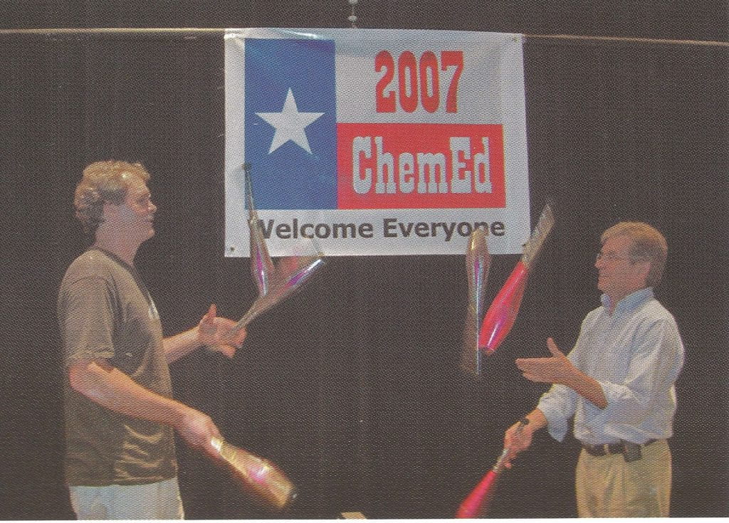 Bill Deese and Rodney Barton juggling in front of a ChemEd 2007 banner